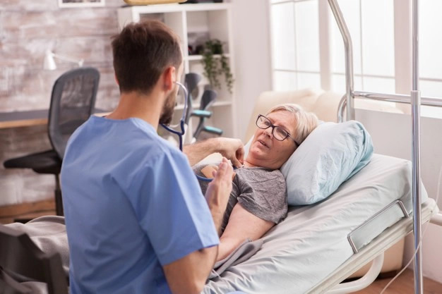 male doctor using stethoscope check woman heart nursing home