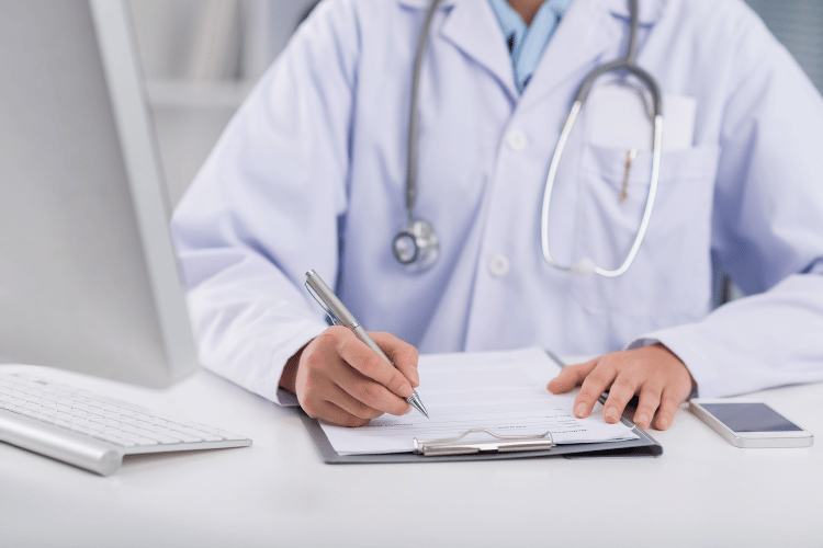 doctor writing notes from electronic medical record